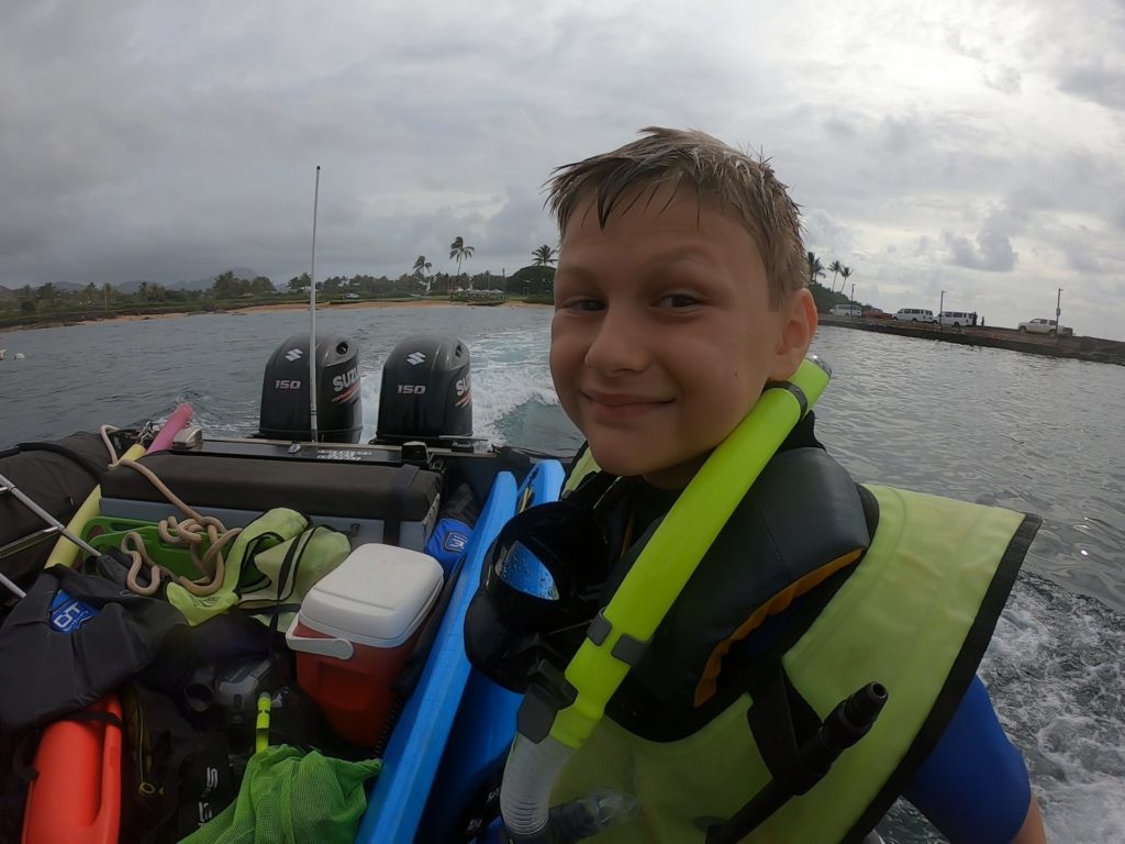 Our oldest son in the boat getting ready to do some snorkeling with Hawaii Z Tourz!