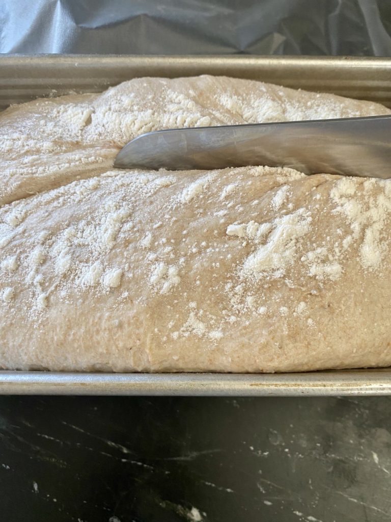Using a serrated knife, make a slash on the top of the loaf.