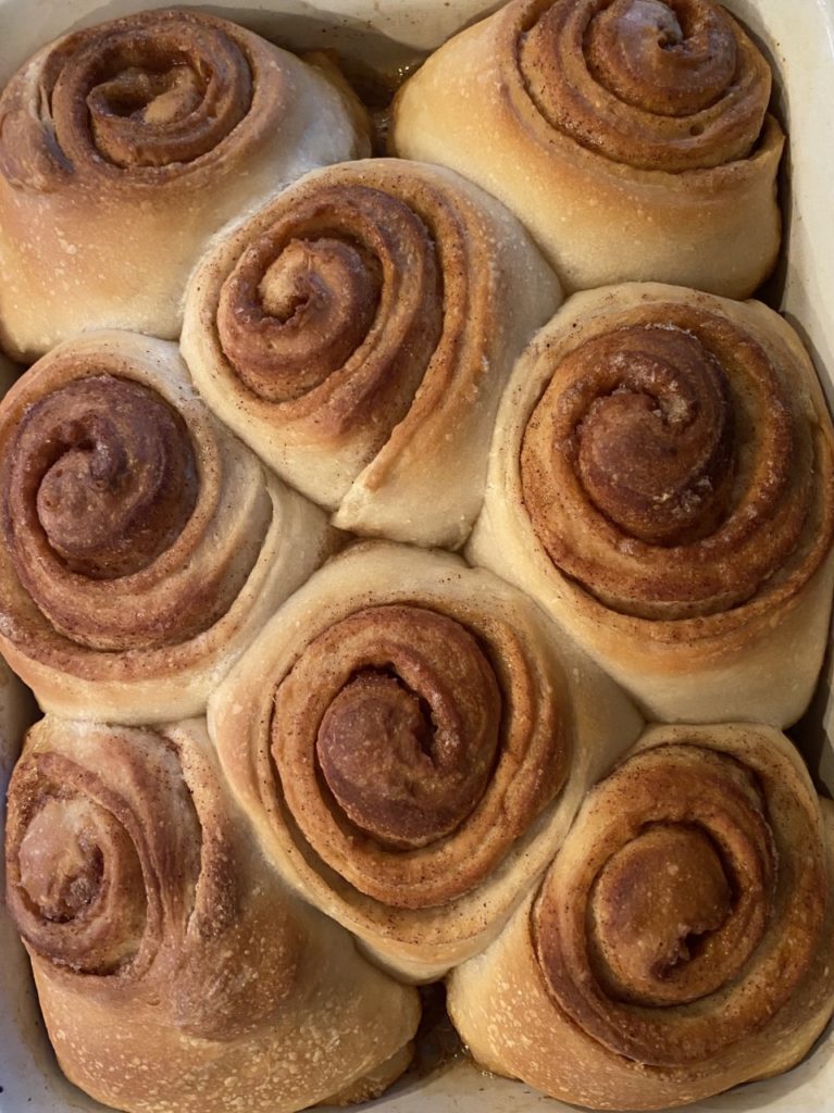 The baked, unfrosted rolls.