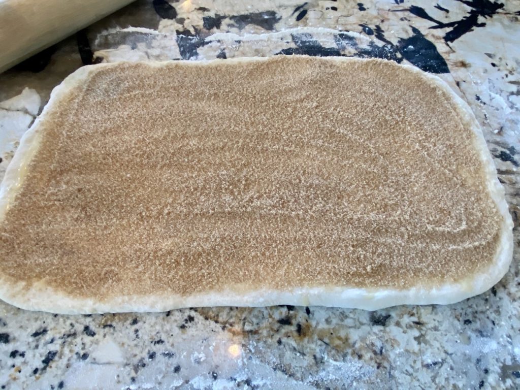 The dough is evenly covered with the sugar mixture.