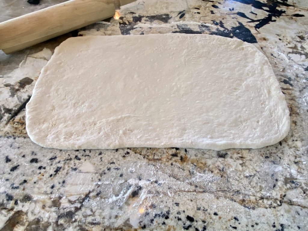 Dough is rolled out into a large rectangle, about 9 x 12 inches.