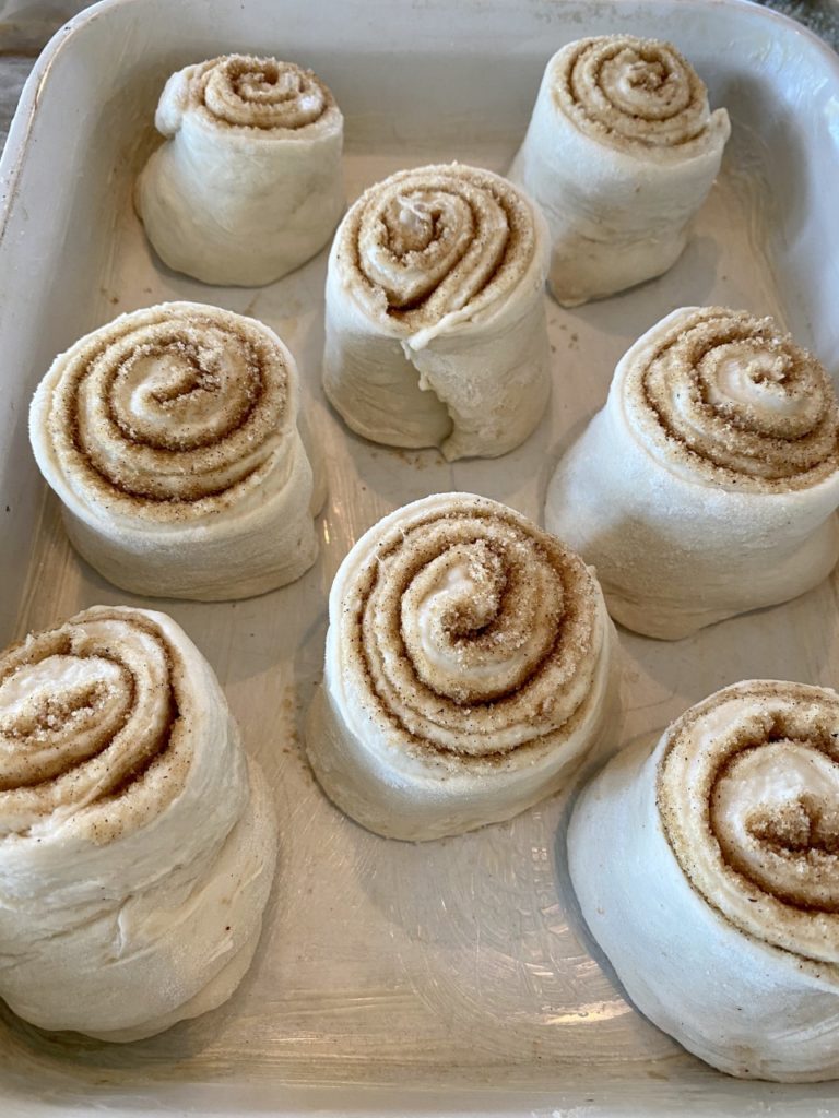 My rolls are placed in the baking dish, cut side up, with a little space in between.