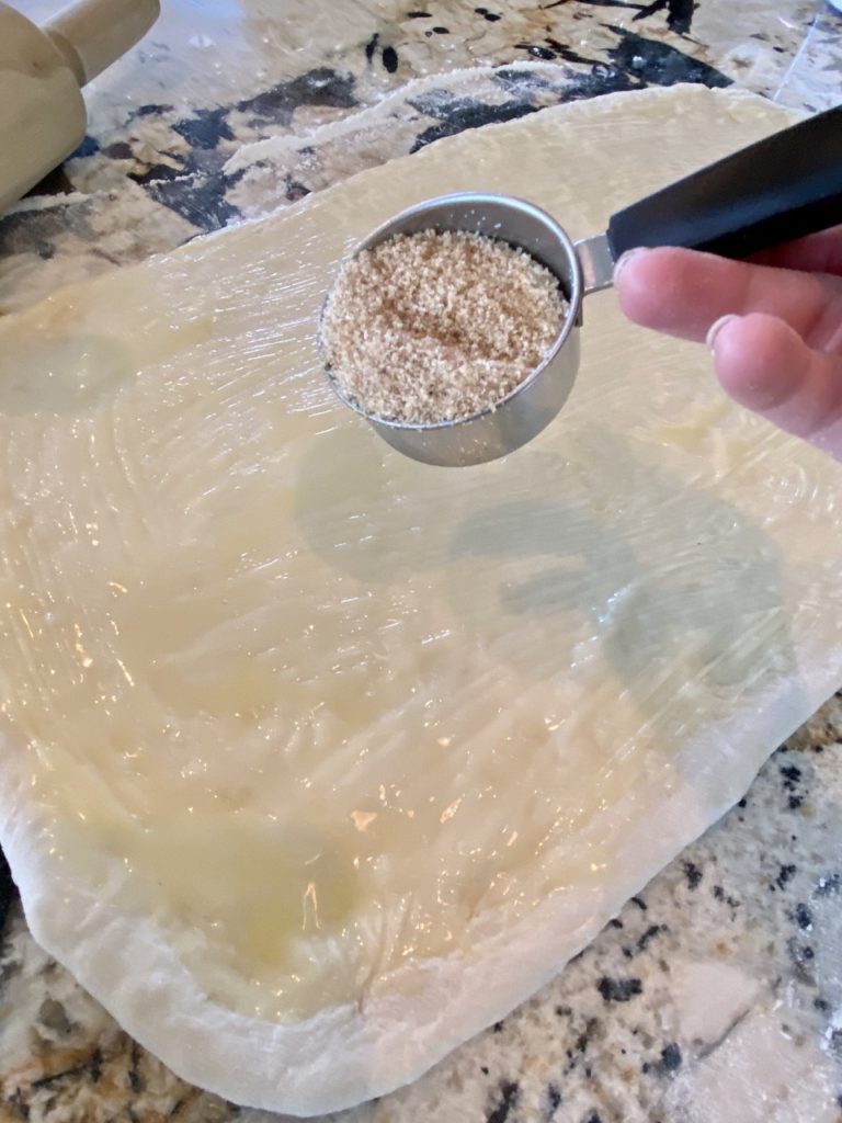 Sprinkling the dough with the sugar mixture. 