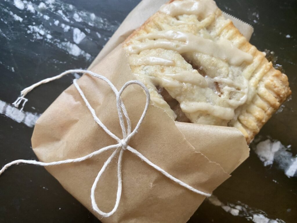 These Spiced Apple Hand Pies with Maple Butter Drizzle are being delivered to friends. 
