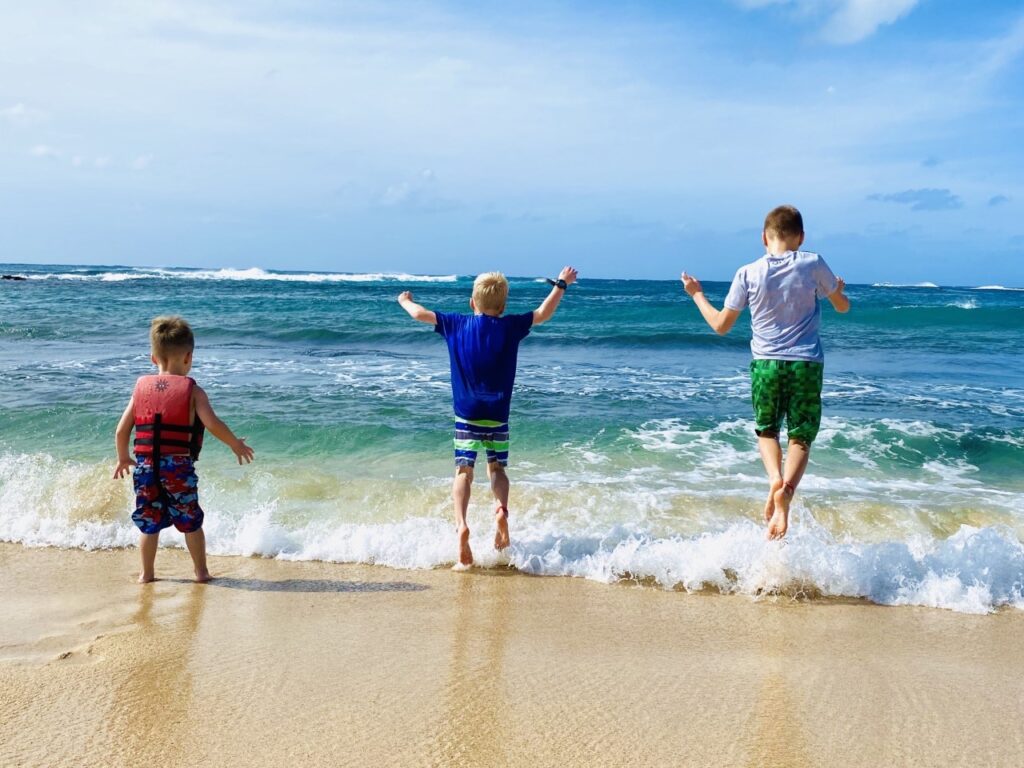 Our boys enjoyed wave jumping at Poipu Beach - Best of Kauai Experiences